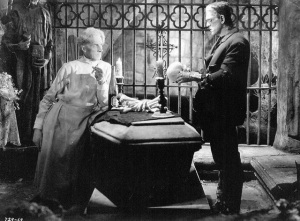 Dr. Pretorious (Ernest Thesiger) schemes with the Monster (Boris Karloff) in THE BRIDE OF FRANKENSTEIN (1935).